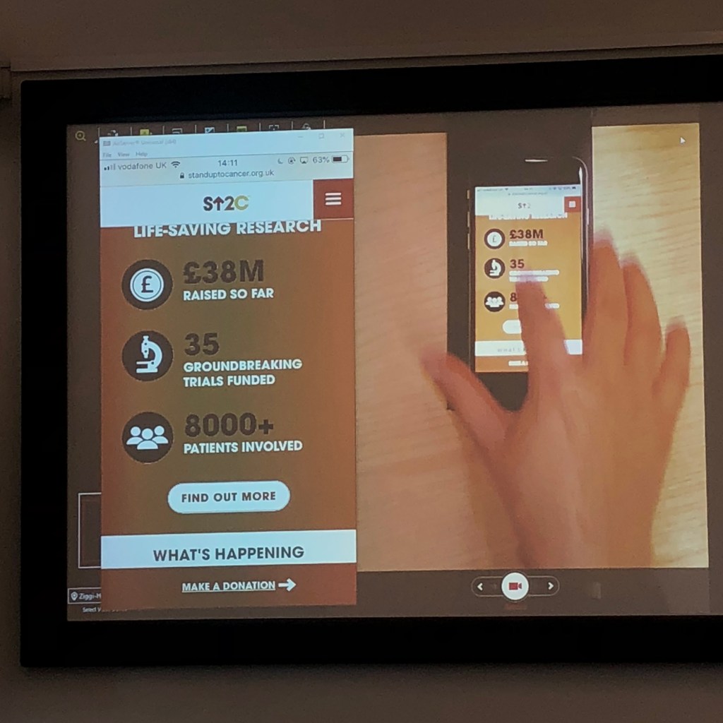 User research participant interacts with a mobile prototype in a usability testing lab